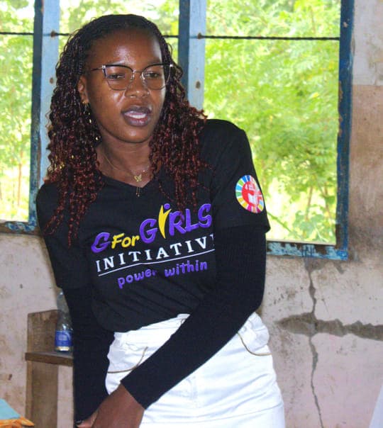 Madam Evince Miyago speaking to Grade 7 girls during pad distribution at Tsuini