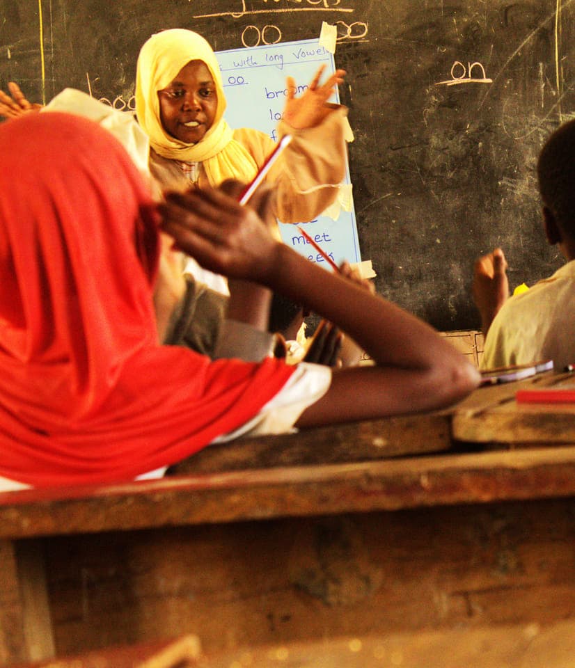 Madam Kijoli leading a learning camp session at Jego
