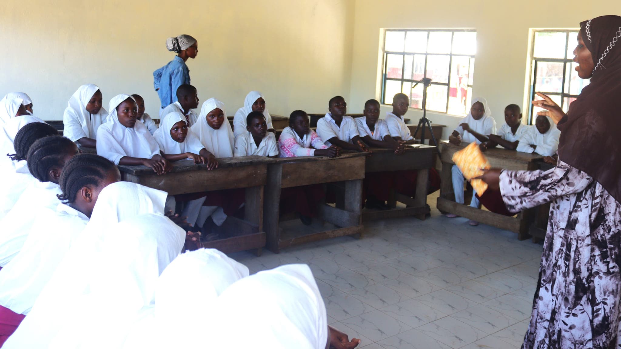 GGI champions explaining how reusable pads are used at Kiwegu JSS