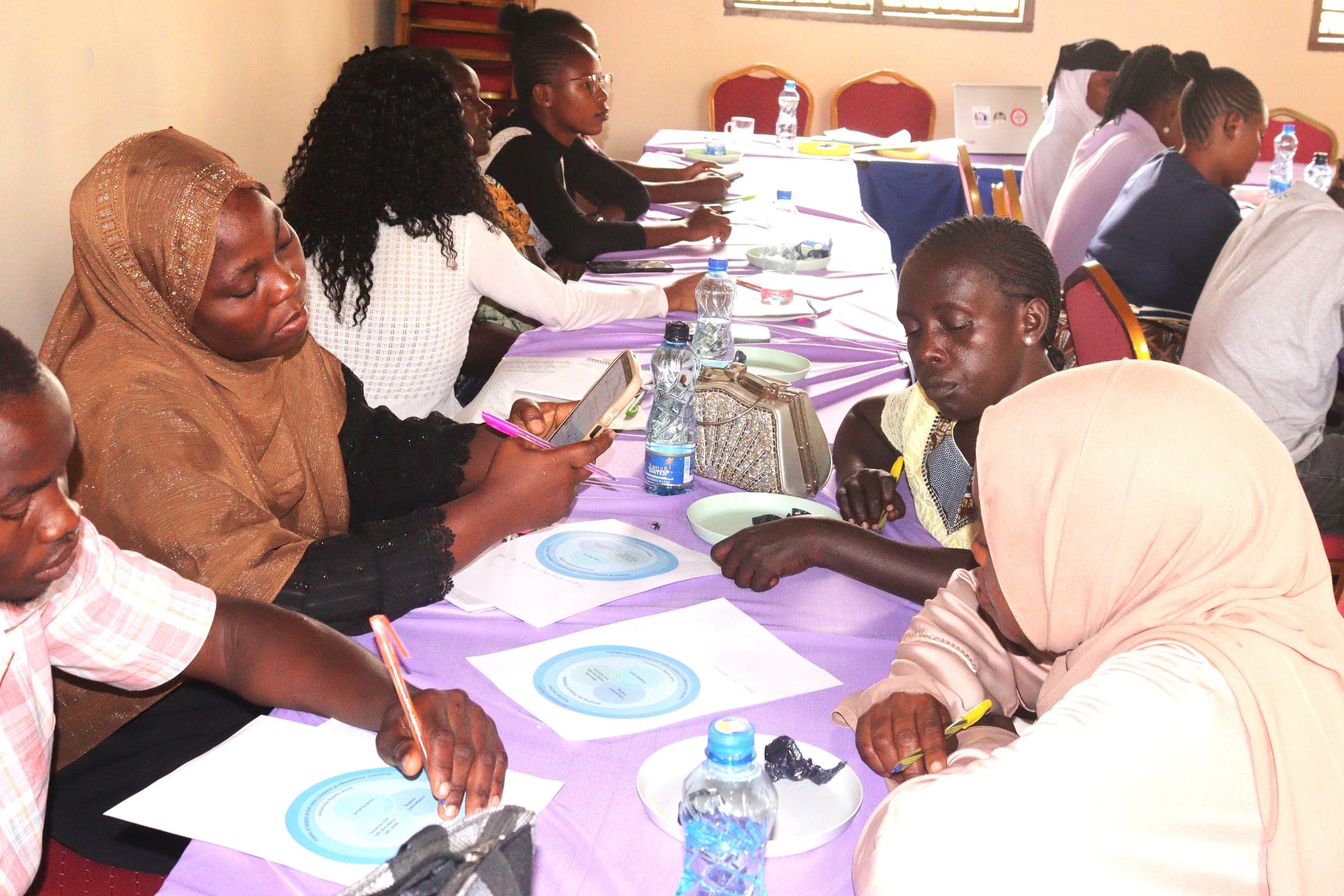 Teachers, community champions and GGI staff at a catch-up meeting
